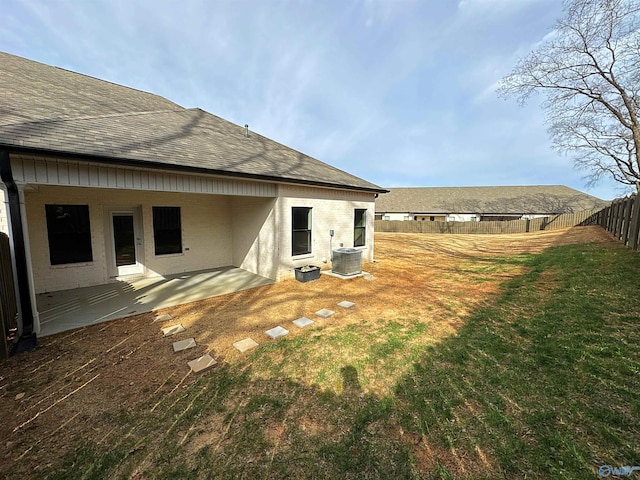 back of house featuring cooling unit, roof with shingles, fence, and a patio