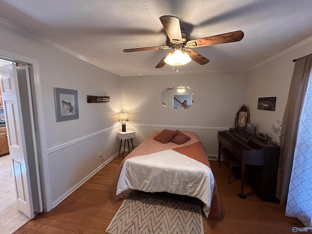 bedroom featuring crown molding, wood-type flooring, a textured ceiling, and ceiling fan