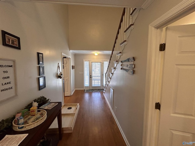 doorway to outside featuring a high ceiling and dark hardwood / wood-style floors