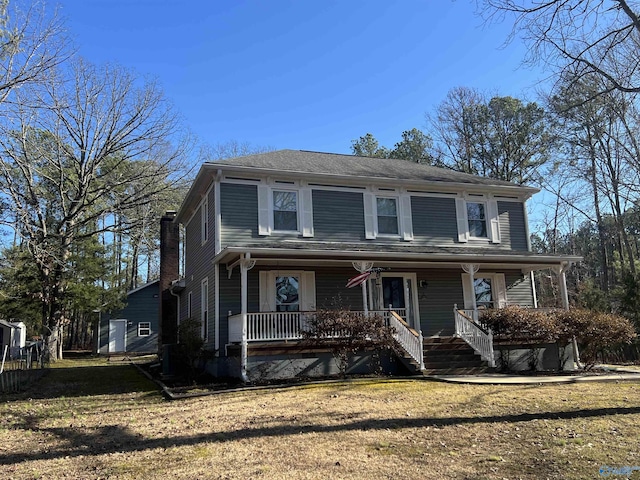 front facade with a front lawn and a porch