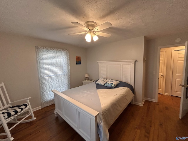 bedroom featuring ceiling fan, a textured ceiling, and dark hardwood / wood-style flooring