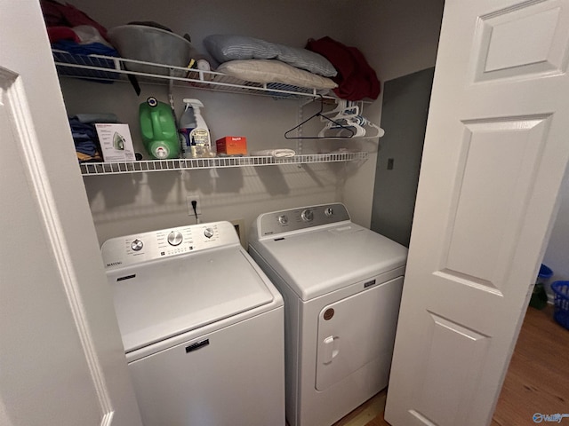 washroom with wood-type flooring and washing machine and clothes dryer