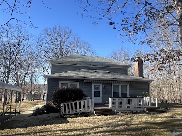 view of front of property with a wooden deck and a front lawn