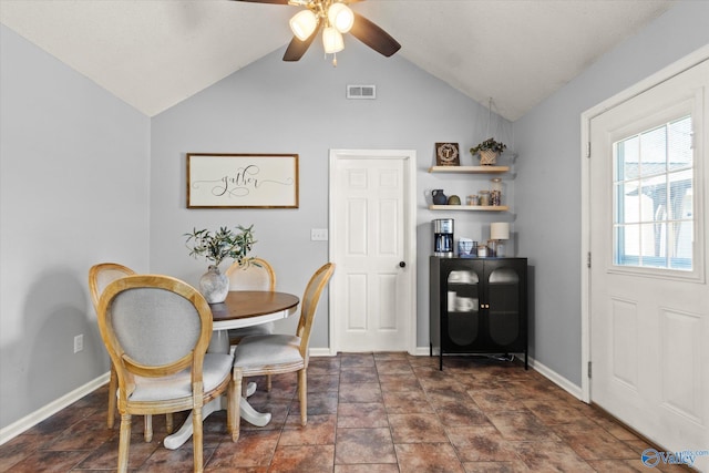 dining area featuring ceiling fan and lofted ceiling