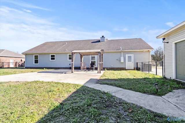 rear view of house with a patio area and a lawn