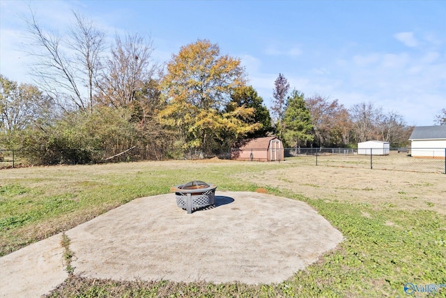 view of yard with a fire pit