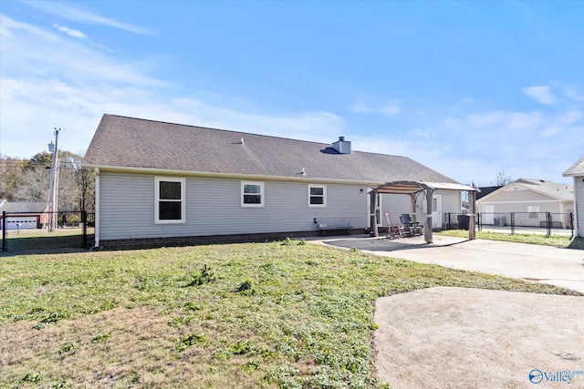 back of house with a pergola, a patio area, and a yard