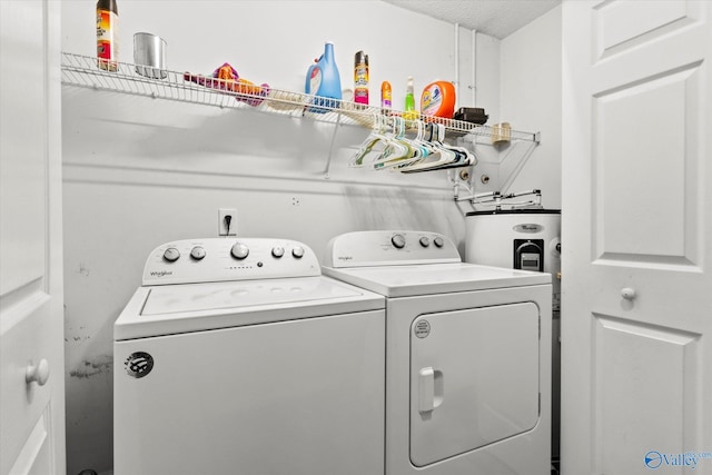 laundry room featuring independent washer and dryer and a textured ceiling