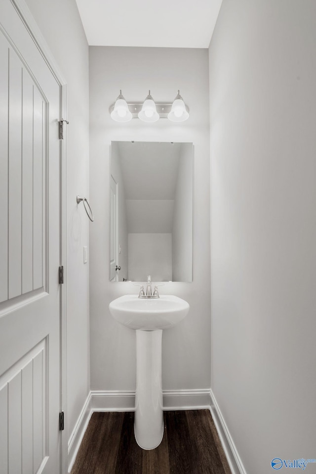 bathroom with wood finished floors and baseboards