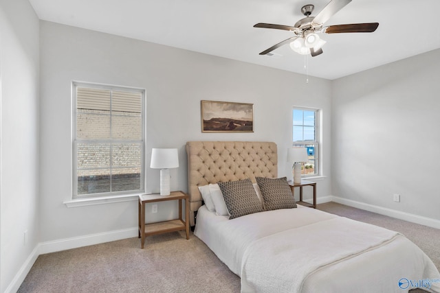 bedroom featuring a ceiling fan, light carpet, visible vents, and baseboards