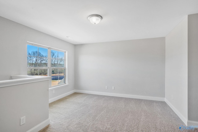 empty room with carpet and baseboards