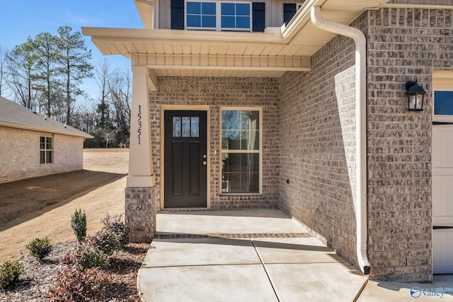 property entrance featuring brick siding