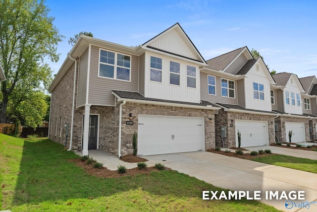 multi unit property featuring board and batten siding, driveway, brick siding, a front lawn, and an attached garage