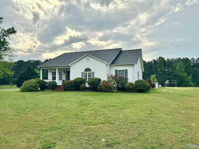 ranch-style house with a porch and a front yard