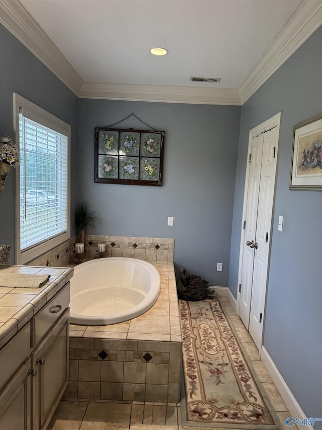 full bath featuring a garden tub, crown molding, visible vents, tile patterned flooring, and vanity