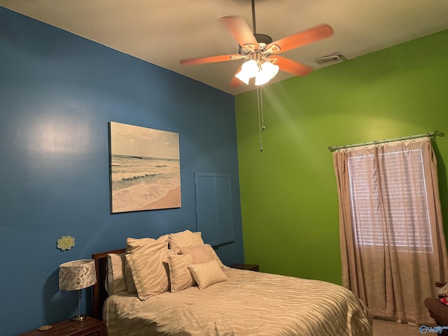 carpeted bedroom featuring ceiling fan and visible vents