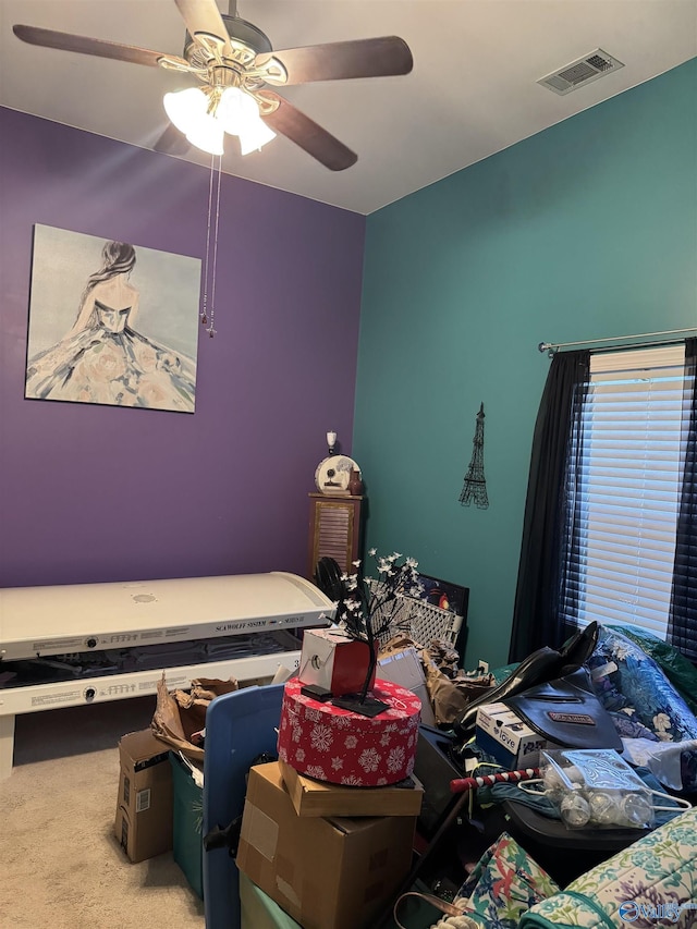 bedroom with carpet, visible vents, and a ceiling fan