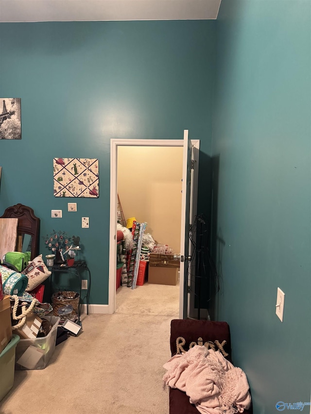 carpeted bedroom featuring baseboards