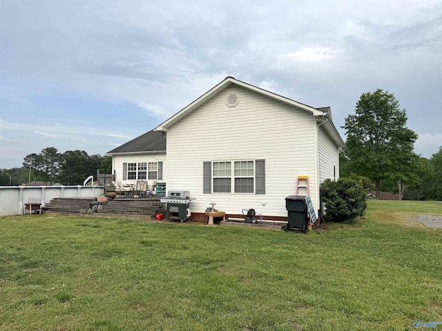 back of house featuring a yard