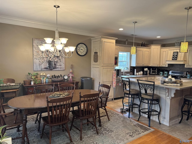 dining area featuring an inviting chandelier, ornamental molding, light wood finished floors, and recessed lighting