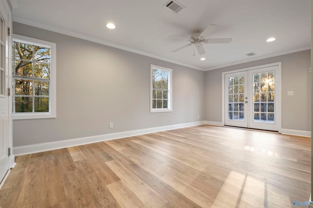 spare room featuring ceiling fan, light hardwood / wood-style floors, crown molding, and french doors