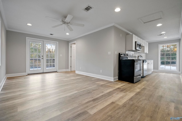 kitchen featuring stainless steel appliances, white cabinetry, a wealth of natural light, and light hardwood / wood-style floors