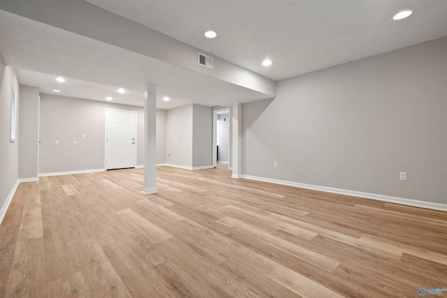 basement with light hardwood / wood-style flooring