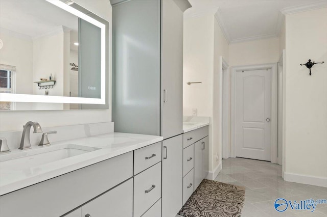 full bath featuring baseboards, vanity, crown molding, and tile patterned flooring