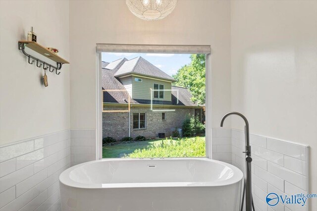 carpeted bedroom featuring ceiling fan and ensuite bath