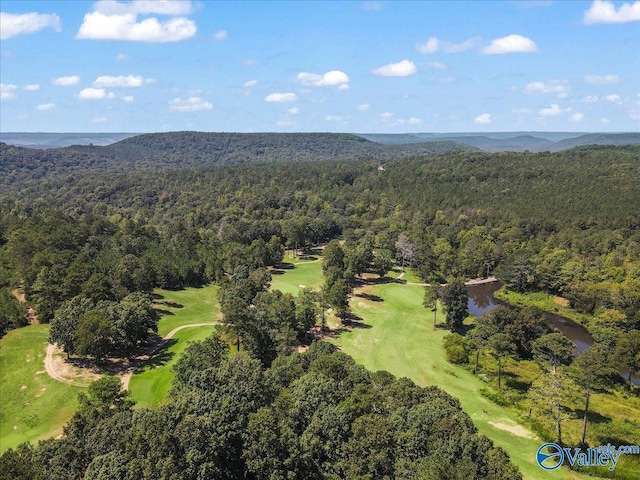 aerial view featuring a mountain view, golf course view, and a view of trees
