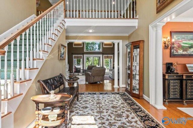 living room with a high ceiling and wood-type flooring