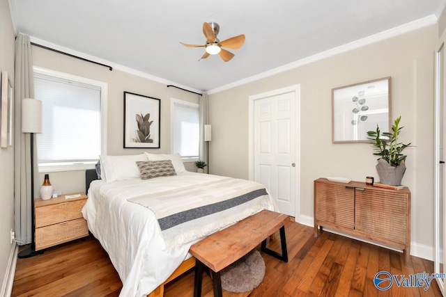 bedroom featuring hardwood / wood-style flooring, baseboards, and ornamental molding