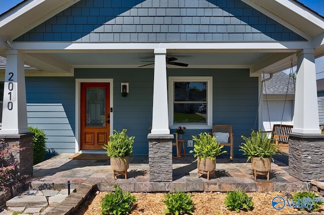 property entrance featuring a ceiling fan and a porch