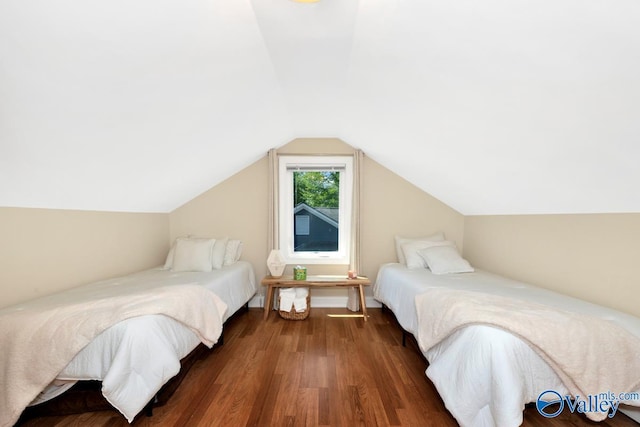 bedroom featuring vaulted ceiling and wood finished floors
