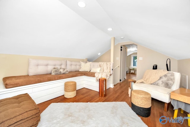 living area featuring lofted ceiling, wood finished floors, recessed lighting, and visible vents