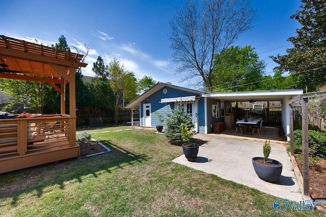 view of yard featuring a wooden deck, a pergola, and fence