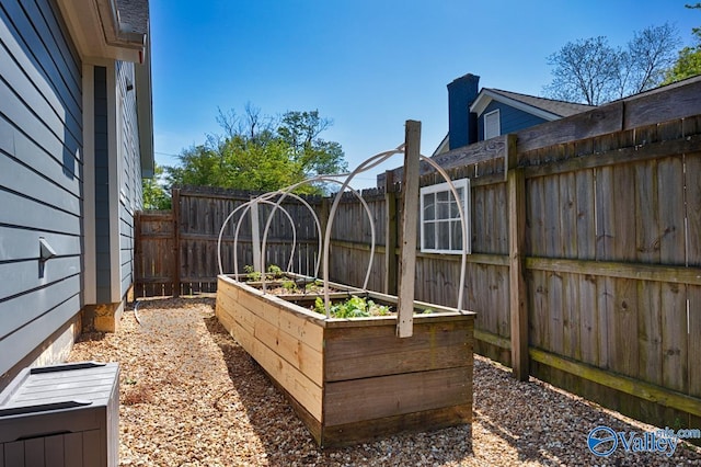 view of yard featuring a fenced backyard and a vegetable garden