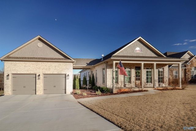 view of front of home featuring a porch and a garage