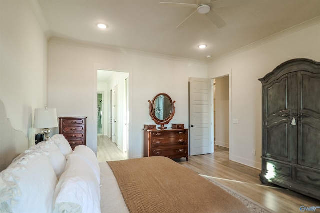 bedroom featuring ceiling fan, crown molding, and light hardwood / wood-style floors