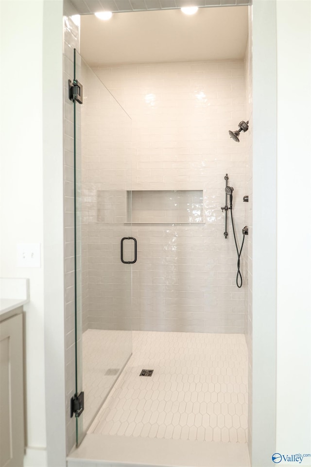 bathroom with a shower with door