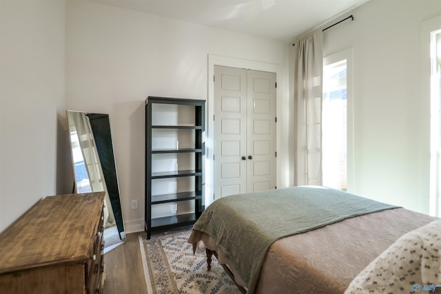 bedroom with a closet and dark hardwood / wood-style flooring