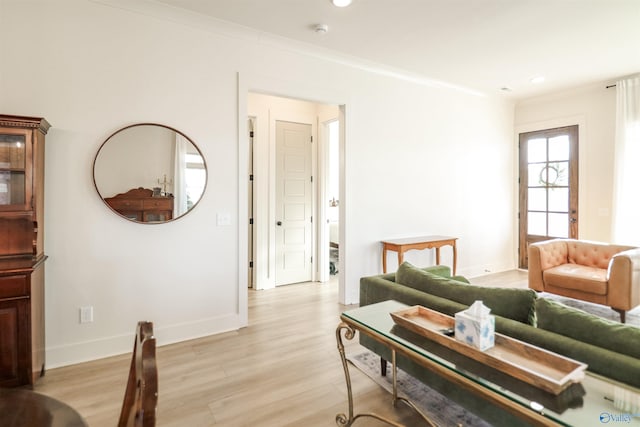 living room with light hardwood / wood-style floors and crown molding