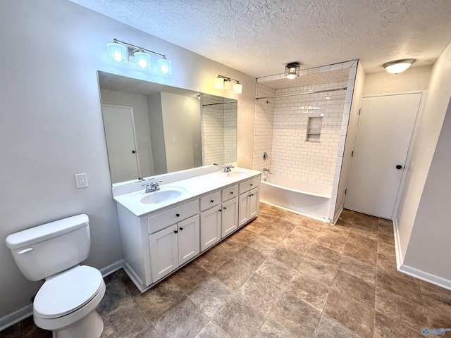 full bath with baseboards, a textured ceiling, a sink, and toilet