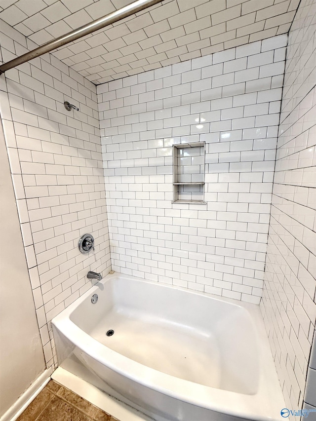bathroom with tile patterned floors and bathtub / shower combination