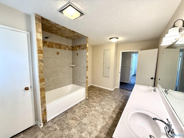 full bath with a sink, baseboards, and  shower combination