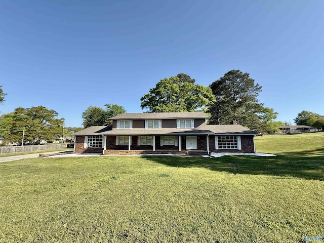 view of front facade featuring a front yard and brick siding