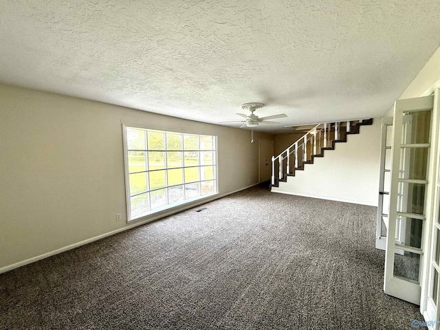 unfurnished living room featuring ceiling fan, baseboards, carpet, and stairs