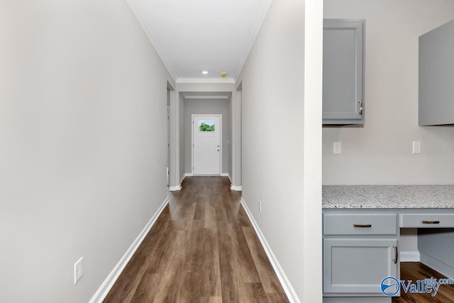 corridor with crown molding and dark hardwood / wood-style floors