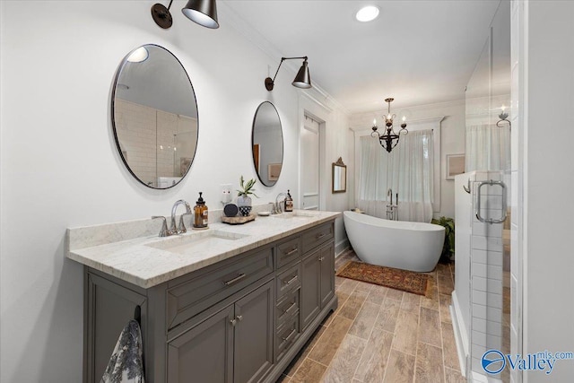 10161 US Highway 11, Springville, AL 35146 - bathroom with a chandelier, crown molding, a soaking tub, double vanity, and a shower with door