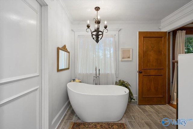 10161 US Highway 11, Springville, AL 35146 - full bath featuring a chandelier, a freestanding bath, baseboards, wood finished floors, and crown molding